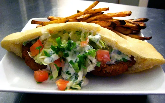 falafel stuffed in pita with tomatoes and tzatziki, plus a side of oven-baked fries
