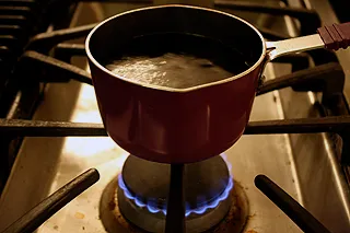 reducing pomegranate juice and sugar into molasses