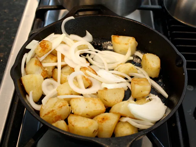 frying the potatoes and onions
