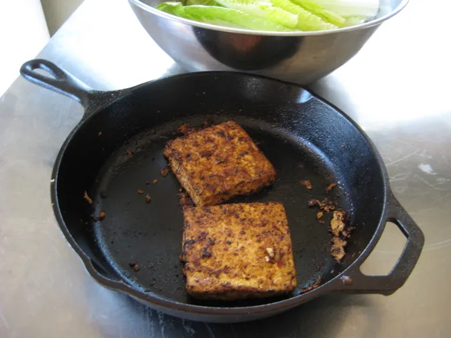 blackened tofu in a cast iron skillet